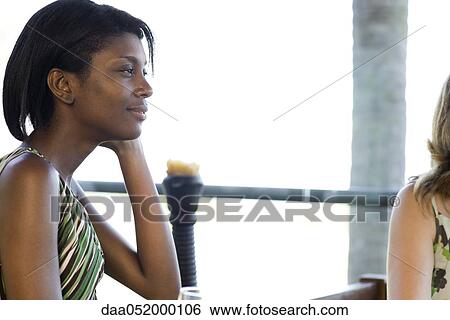 Young woman looking away in thought View Large Photo Image Stock Photograph - Young woman looking away in thought. Fotosearch