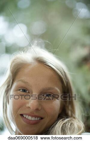 Stock Photo - Young woman, low angle view. Fotosearch