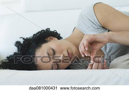 Young woman lying down, contemplating fingers View Large Photo Image Stock Image - Young woman lying down, contemplating fingers. Fotosearch
