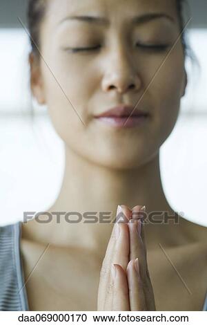 Young woman meditating in prayer position View Large Photo Image Stock Image - Young woman meditating in prayer position. Fotosearch