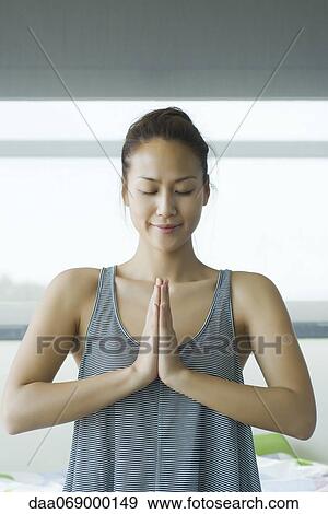 Young woman meditating in prayer position View Large Photo Image Stock Photo - Young woman meditating in prayer position. Fotosearch