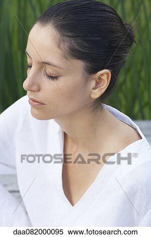 Young woman meditating with eyes closed, portrait View Large Photo Image Stock Photography - Young woman meditating with eyes closed, portrait. Fotosearch