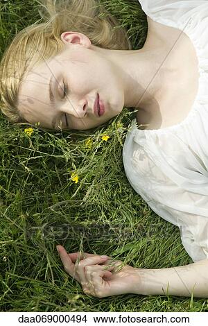 Young woman napping on grass View Large Photo Image Picture - Young woman napping on grass. Fotosearch