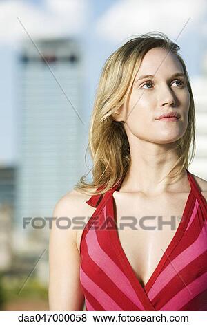 Young woman outdoors, looking up, portrait View Large Photo Image Stock Photo - Young woman outdoors, looking up, portrait. Fotosearch