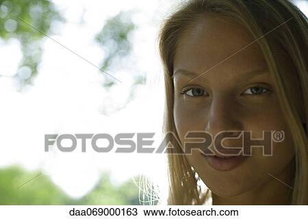 Stock Image - Young woman outdoors, portrait. Fotosearch