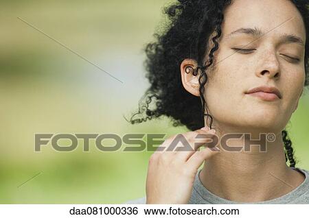 Young woman outdoors with eyes closed, portrait View Large Photo Image Stock Photograph - Young woman outdoors with eyes closed, portrait. Fotosearch