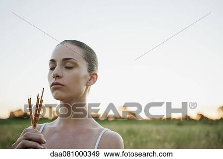 Young woman praying outdoors, holding incese sticks View Large Photo Image Stock Photo - Young woman praying outdoors, holding incese sticks. Fotosearch