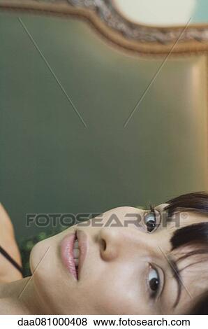Young woman reclining, portrait View Large Photo Image Stock Photo - Young woman reclining, portrait. Fotosearch