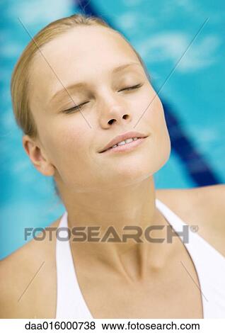 Young woman relaxing by pool, portrait View Large Photo Image Stock Photo - Young woman relaxing by pool, portrait. Fotosearch