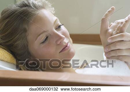 Young woman relaxing in bubble bath View Large Photo Image Stock Image - Young woman relaxing in bubble bath. Fotosearch