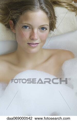Young woman relaxing in bubble bath, portrait View Large Photo Image Stock Image - Young woman relaxing in bubble bath, portrait. Fotosearch