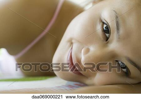 Young woman relaxing on bed, cropped View Large Photo Image Stock Image - Young woman relaxing on bed, cropped. Fotosearch
