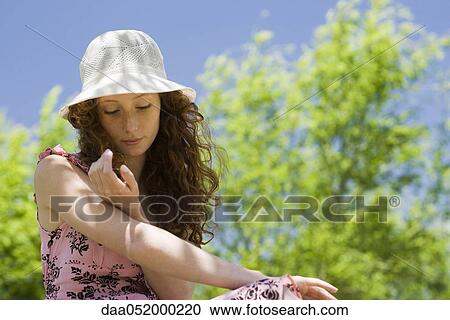 Stock Image - Young woman relaxing outdoors. Fotosearch