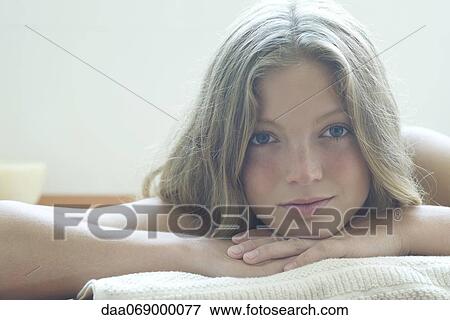 Young woman resting head on arms, portrait View Large Photo Image Stock Photo - Young woman resting head on arms, portrait. Fotosearch