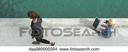 Young woman sitting beside canal, using laptop computer, elevated view View Large Photo Image Picture - Young woman sitting beside canal, using laptop computer, elevated view. Fotosearch