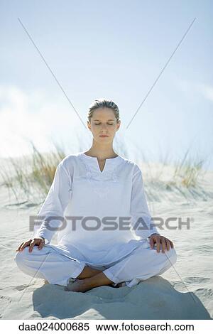 Young woman sitting on dune, eyes closed View Large Photo Image Stock Photography - Young woman sitting on dune, eyes closed. Fotosearch