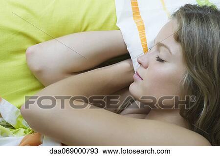 Young woman sleeping View Large Photo Image Stock Image - Young woman sleeping. Fotosearch