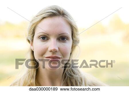 Young woman smiling at camera, portrait View Large Photo Image Stock Photo - Young woman smiling at camera, portrait. Fotosearch
