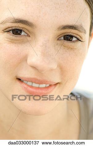 Young woman smiling at camera, portrait View Large Photo Image Stock Photo - Young woman smiling at camera, portrait. Fotosearch