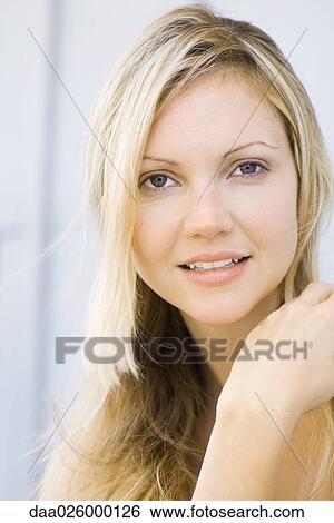 Young woman smiling at camera, portrait View Large Photo Image Stock Photograph - Young woman smiling at camera, portrait. Fotosearch