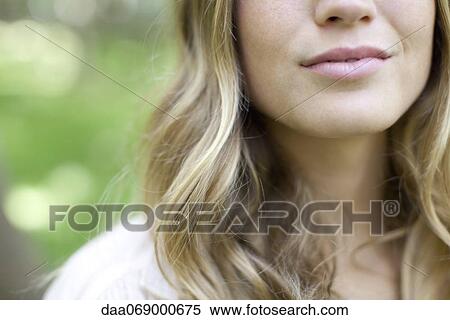 Young woman smiling, cropped View Large Photo Image Stock Photography - Young woman smiling, cropped. Fotosearch