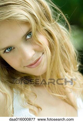Stock Photo - Young woman smiling, head and shoulders, portrait. Fotosearch