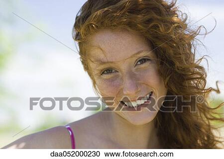 Stock Image - Young woman smiling, portrait. Fotosearch