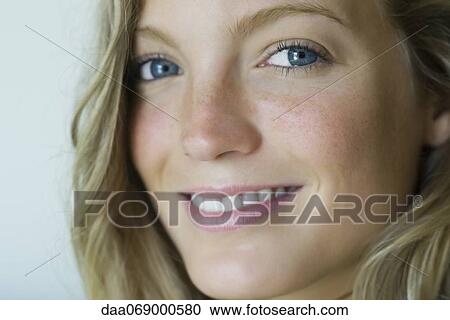 Stock Image - Young woman smiling, portrait. Fotosearch