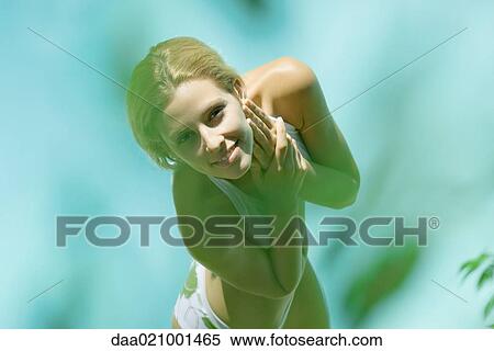 Young woman standing in bikini, high angle view, blur in foreground View Large Photo Image Stock Photography - Young woman standing in bikini, high angle view, blur in foreground. Fotosearch