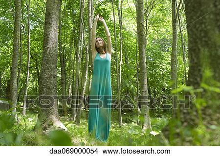 Young woman stretching in woods View Large Photo Image Picture - Young woman stretching in woods. Fotosearch
