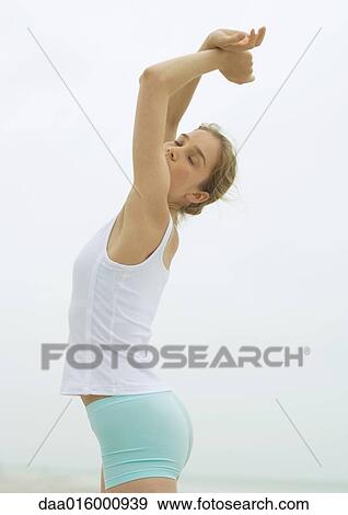 Young woman stretching View Large Photo Image Stock Photo - Young woman stretching. Fotosearch