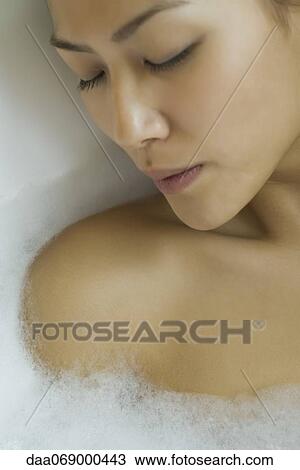 Young woman taking bubble bath, cropped View Large Photo Image Stock Image - Young woman taking bubble bath, cropped. Fotosearch