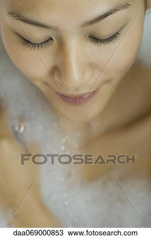 Young woman taking bubble bath, high angle view View Large Photo Image Stock Image - Young woman taking bubble bath, high angle view. Fotosearch
