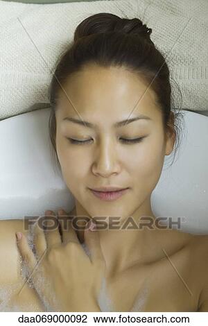 Young woman taking bubble bath View Large Photo Image Stock Image - Young woman taking bubble bath. Fotosearch