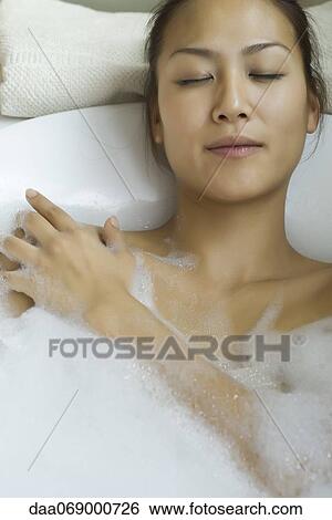 Young woman taking bubble bath View Large Photo Image Stock Photograph - Young woman taking bubble bath. Fotosearch