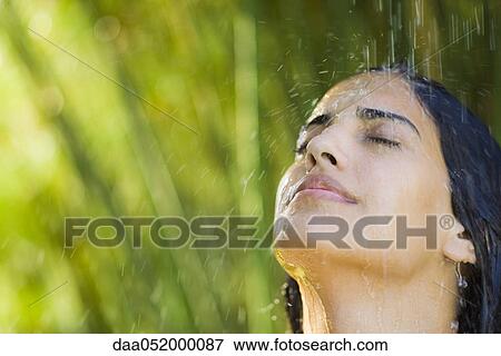 Young woman under falling water, portrait View Large Photo Image Stock Photo - Young woman under falling water, portrait. Fotosearch