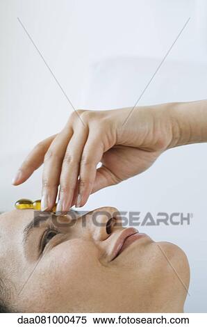 Young woman undergoing hot stone therapy View Large Photo Image Stock Photography - Young woman undergoing hot stone therapy. Fotosearch