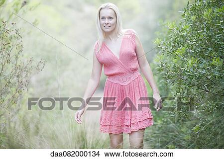 Picture - Young woman walking in nature. Fotosearch