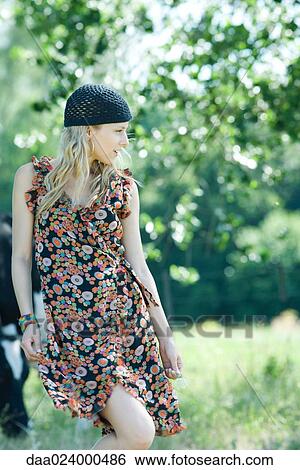 Young woman walking in rural setting, looking away View Large Photo Image Stock Photograph - Young woman walking in rural setting, looking away. Fotosearch