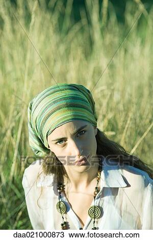 Young woman wearing scarf around head, in field, portrait View Large Photo Image Stock Image - Young woman wearing scarf around head, in field, portrait. Fotosearch