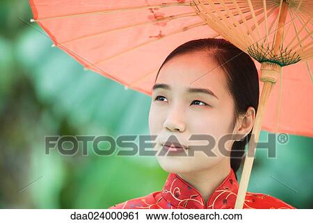 Young woman wearing traditional Chinese clothing, holding parasol View Large Photo Image Stock Image - Young woman wearing traditional Chinese clothing, holding parasol. Fotosearch