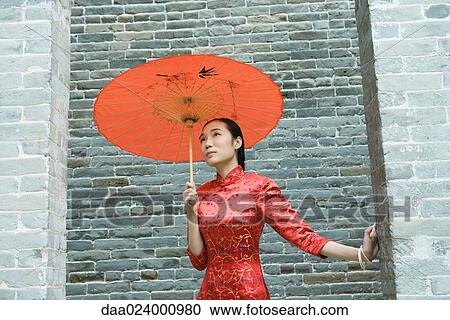 Young woman wearing traditional Chinese clothing, standing with parasol, waist up View Large Photo Image Stock Image - Young woman wearing traditional Chinese clothing, standing with parasol, waist up. Fotosearch