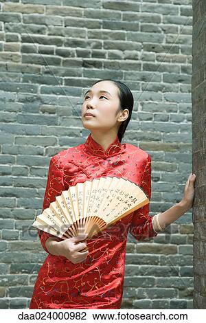 Young woman wearing traditional Chinese clothing, holding fan View Large Photo Image Stock Image - Young woman wearing traditional Chinese clothing, holding fan. Fotosearch