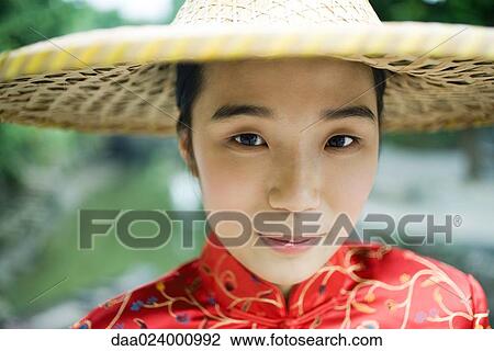 Young woman wearing traditional Chinese clothing and hat, portrait View Large Photo Image Stock Image - Young woman wearing traditional Chinese clothing and hat, portrait. Fotosearch