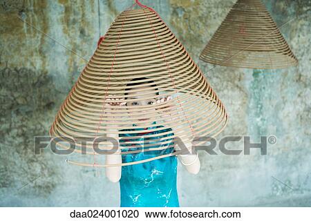 Young woman wearing traditional Chinese clothing, looking through spiral of incense View Large Photo Image Stock Image - Young woman wearing traditional Chinese clothing, looking through spiral of incense. Fotosearch