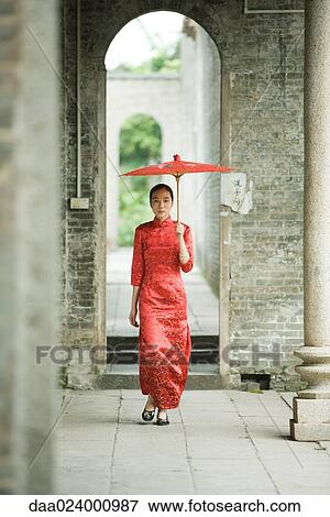 Young woman wearing traditional Chinese clothing, walking with parasol View Large Photo Image Stock Photo - Young woman wearing traditional Chinese clothing, walking with parasol. Fotosearch