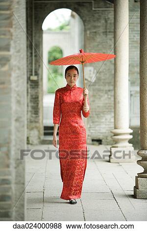 Young woman wearing traditional Chinese clothing, walking with parasol View Large Photo Image Stock Photo - Young woman wearing traditional Chinese clothing, walking with parasol. Fotosearch
