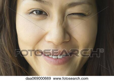 Young woman winking, cropped View Large Photo Image Stock Photo - Young woman winking, cropped. Fotosearch