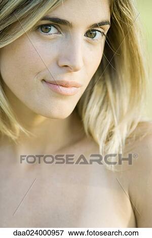 Stock Photo - Young woman with bare shoulders looking at camera, portrait. Fotosearch