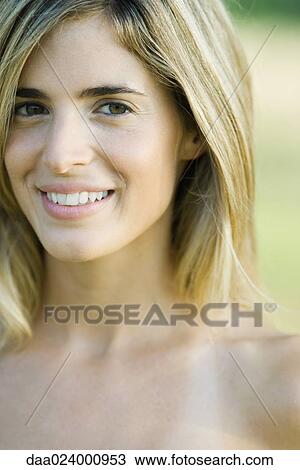 Young woman with bare shoulders smiling at camera, cropped portrait View Large Photo Image Stock Image - Young woman with bare shoulders smiling at camera, cropped portrait. Fotosearch